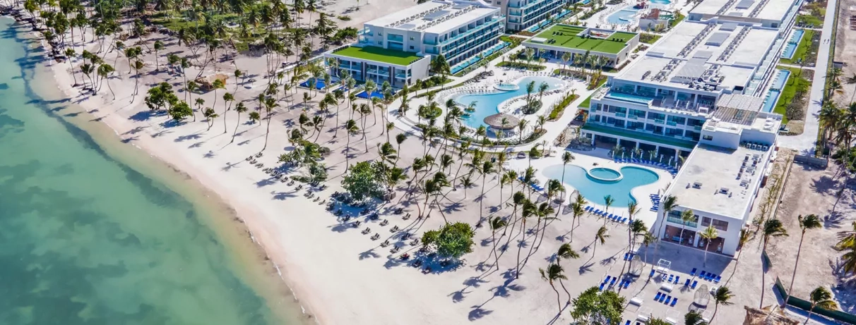 vue aérienne hôtel et plage, piscine, palmiers, eau turquoise, sable blanc, transats