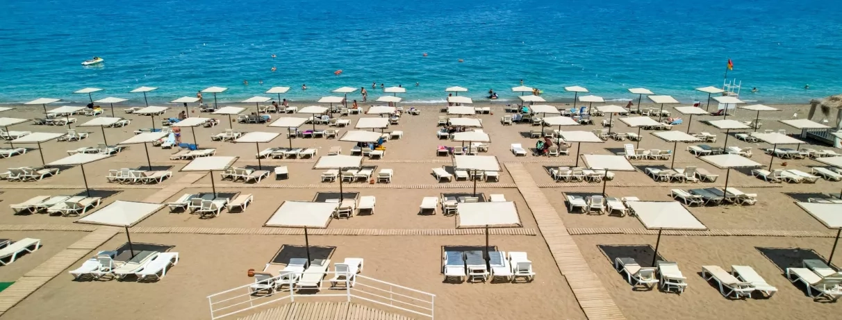 plage avec transats et parasols et eau turquoise