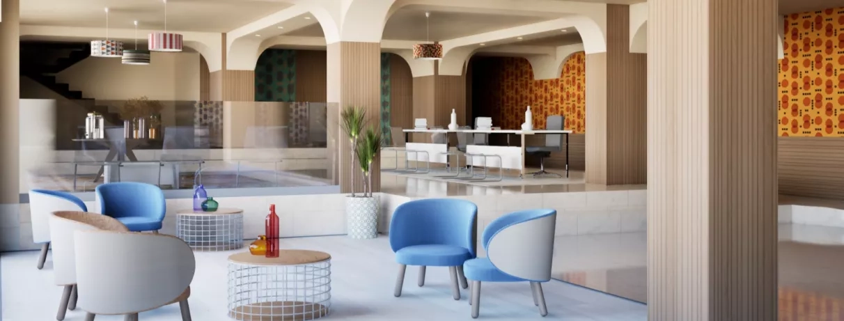 Un hall d'entrée avec plusieurs fauteuils gris, deux petites tables basses, ainsi que deux bureaux de réception