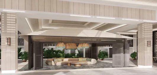 Réception, grand canapé et petites tables basses, plantes vertes