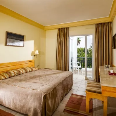 Chambre double standard lumineuse avec balcon, décorée dans des tons sobres