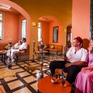 Deux couples fumant le narguilé au café maure de l'hôtel 