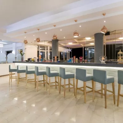 bar horizon avec des chaises hautes sur le comptoir et tables basses à la terrasse