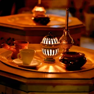Ambiance orientale feutrée avec service de café traditionnel tunisien au Royal Garden Palace à Djerba.