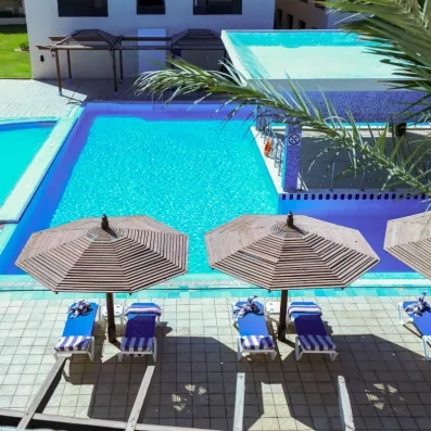 piscine extérieur, avec terrasse bar au milieu, transats, parasols, soleil 