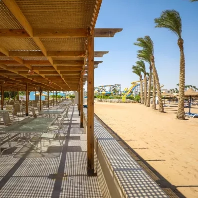 terrasse extérieur au bord de la plage, avec toit en bois pour l'ombre, soleil, palmiers 