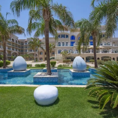 Jardins tropicaux, bassins décoratifs et architecture élégante du Premier Le Rêve Hôtel & Spa en Égypte.
