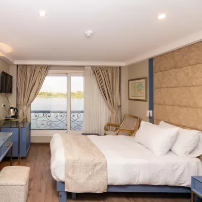 Cabine confortable avec lit double et décoration traditionnelle à bord d'une croisière fluviale sur le Nil.