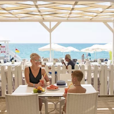 table et chaise sur la terrasse face à la plage