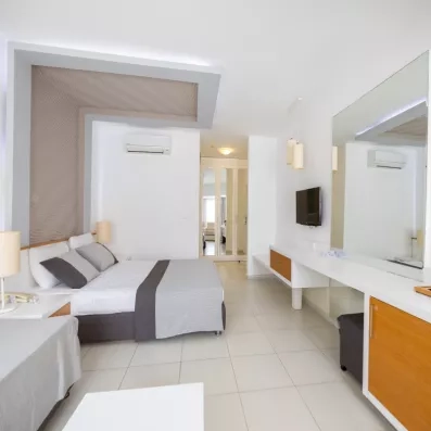 chambre avec un lit double et une télévision murale 