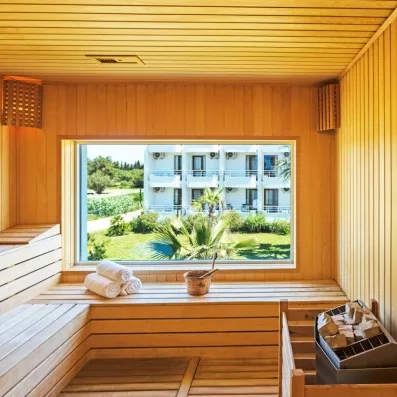 Un sauna en bois clair offrant une vue relaxante sur les jardins extérieurs.