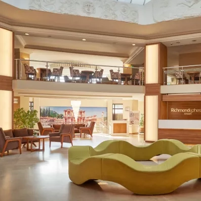 Le hall d'accueil spacieux, doté d'un comptoir en bois moderne et d'un canapé.