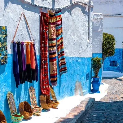 Ruelle de la médina de Rabat, façades claires, portes décorées et atmosphère paisible dans la capitale du Maroc.